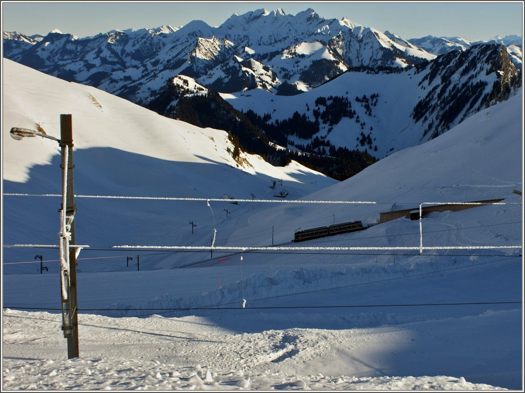 Zwischen den winterlichen Fahrleitungsdr�hten f�hrt ein Rochers-de-Naye Triebzug talw�rts.
(12.01.2012) 