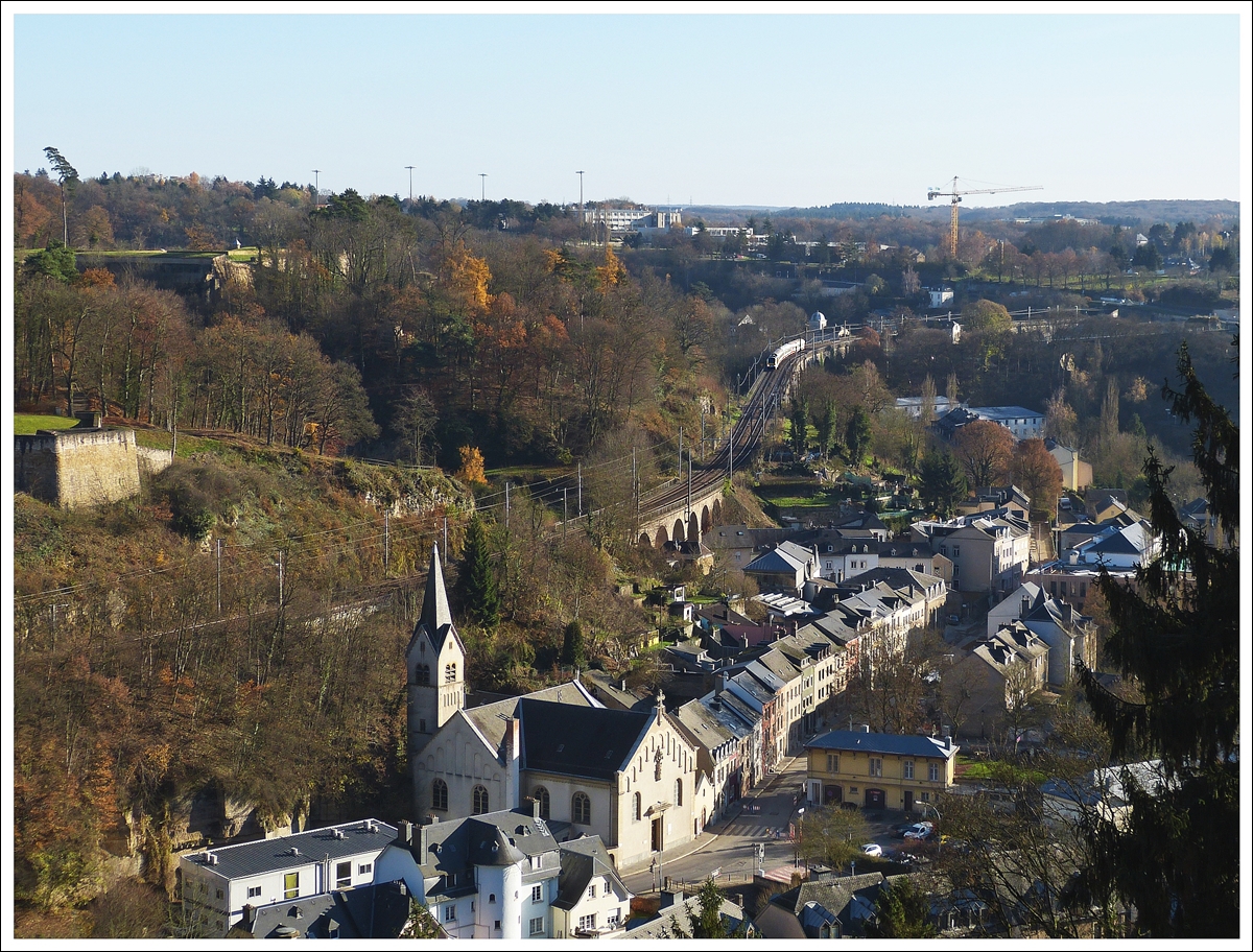 . Ein Zugsuchbild - Von der Grande-Duchesse Charlotte Brücke (Roud Bréck) in Luxemburg Stadt hat man eine schöne Aussicht auf den Stadtteil Pfaffental und man sieht hervorragned die Streckenführung der Nordstrecke innerhalb der Hauptstadt.

Der IR 114 Luxembourg - Liers hat am 02.12.2013 den Pfaffentaler Viadukt hinter sich gelassen und fährt nun dem Grünewald Viadukt entgegen. (Hans)