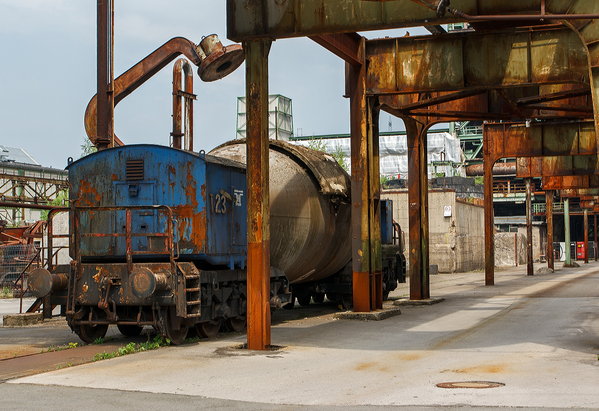 Der achtachsige ATH Thyssen Torpedopfannenwagen T 23 (86002) am 05.06.2011 im LWL-Industriemuseum Henrichsh�tte in Hattingen. Mit 8 Achsen (2 x4) ist dieser Torpedowagen ein recht kleiner Wagen. 

Der Torpedowagen (auch Torpedopfannenwagen oder Roheisenmischerwagen genannt) ist ein Pfannenwagen, dessen Pfanne (der Roheisenmischer) eine an einen Torpedo erinnernde Form hat. Ein langgestreckter Beh�lter mit rundem Querschnitt zwischen zwei Drehgestellen. Die Wagen haben au�er dem Beh�lter selbst keinen Rahmen zwischen den Drehgestellen, damit der Beh�lter m�glichst gro� dimensioniert werden kann.

Die heutigen Hoch�fen besitzen eine untere Etage, durch die direkt Eisenbahnz�ge fahren k�nnen. Das Roheisen rinnt dabei w�hrend des Abstichs in die bereitgestellten Pfannenwagen, die die Form von Zigarren (sogenannte Torpedowagen) besitzen.In den Wagen wird das noch fl�ssige Roheisen zur Weiterverarbeitung zum Konverter ins Stahlwerk bef�rdert.

Damit das �ber 1.400 �C hei�e Roheisen beim Transport nicht zu sehr abk�hlt und die Wagen nicht besch�digt werden, sind die Pfannen im Inneren doppelwandig mit Schamottesteinen ausgekleidet. Bei Fahrten au�erhalb der Werksgel�nde werden zwischen die Pfannenwagen h�ufig leere Flachwagen als Abstandshalter in die Zugkomposition eingef�gt, um eine zu hohe Fl�chenbelastung auf Br�cken zu vermeiden. Auf den Werksgel�nden werden Br�cken m�glichst vermieden bzw. sind  ausreichend stark ausgelegt.

Ein typischer Torpedowagen fasst zwischen 160 und 320 Tonnen fl�ssigen Roheisens, ein Zug besteht aus vier bis sechs solcher Wagen. Torpedowagen lassen sich fest verschlie�en und k�nnen das Eisen wesentlich l�nger fl�ssig halten (bis zu 30 Stunden) als normale Pfannenwagen.
