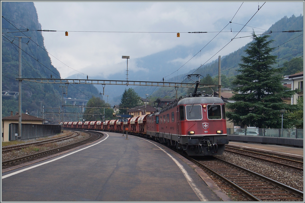 Eine  Re 10/10  mit der führenden Re 6/6 11609 mit einem Kieswagenzug bei der Durchfahrt in Faido Richtung Süden.
22. Sept. 2015