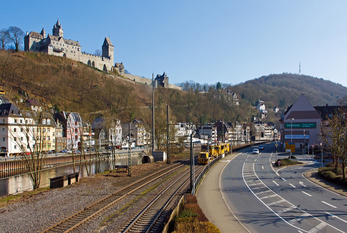 
Eine Stopfmaschine und eine Schotterplaniermaschinen der DGU - Deutsche Gleisbau Union (Koblenz), fahren am 08.03.2014 über die Ruhr-Sieg-Strecke (KBS 440) durch Altena in Richtung Kreuztal.

Oben auf dem Berg die Burg Altena.