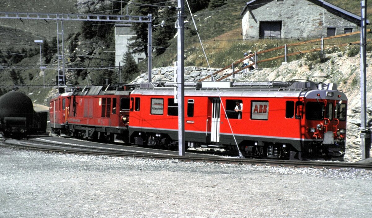 RhB ABe 4/4 Nr.56 vor dem nächsten Zug vorgehängt an Gem 4/4 Nr.801 und ABe 4/4 Nr.41 in Alp Grüm im August 1990. Der Triebwagen Nr.56 hatte bei der Überführung einen Defekt an einer der vier Bremssysteme und wurde hier als Steuerwagen für den Zug vorgehängt.