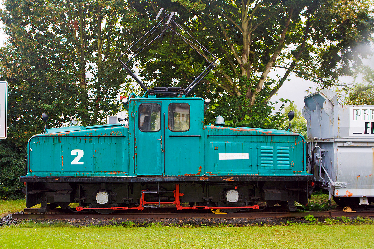 
Seit 1997 steht sie mit einigen andern Fahrzeugen in Wölfersheim als Denkmal und erinnert an den Kohlenbergbau. 
Die ehemalige Lok 2 der Preussen Elektra am 18.08.2014 in Wölfersheim-Södel. 

Die Lok wurde 1954 von Krupp unter der Fabriknummer  3390 gebaut, der elektrische Teil ist von AEG (Fabriknummer 7316), und an die Hefrag Kohlenbahn in Wölfersheim ausgeliefert. 

Technische Daten: 
Achsformel: Bo
Leistung:  360 kW (2x 180 kW)
Gewicht:  33 t
Spurweite:  900 mm
Höchstgeschwindigkeit: 45 km/h

In der Wetterau wurde bis 1991 Braunkohle, im Tief- und Tagebau abgebaut, ab 1913 wurde die Braunkohle auch zur Stromerzeugung verwendet. Ab den 1954 erfolgte die Stromerzeugung in einem größeren Umfang, so wurde auch die 900 mm Grubenbahn elektrifiziert (1200 V Gleichstrom).  Das Streckennetz wurde jeweils den Erfordernissen (Lage der Gruben) angepasst, die größte Streckenlänge war ca. 23 km.

Mit der Grubenbahn (im Volksmund  Kohlebähnchen  genannt) erfolgte der Transport der abgebauten Braunkohle von den Tagebaubetrieben zum Kraftwerk Wölfersheim einerseits. Aber auch die anfallende Asche im Kraftwerk Wölfersheim (ca. 1000 t pro Tag) musste weg und wurde mit der Grubenbahn vom Kraftwerk zu einem alten Tagebau bei Heuchelheim gefahren und dort abgekippt. 

Der Betreiber war die HEFRAG, später PreussenElektra (offizieller Name Preußische Elektrizitäts Aktiengesellschaft, frühere Abkürzung PREAG, eine Tochter der VEBA AG), Konzernnachfolger ist heute die E.ON Energie.
