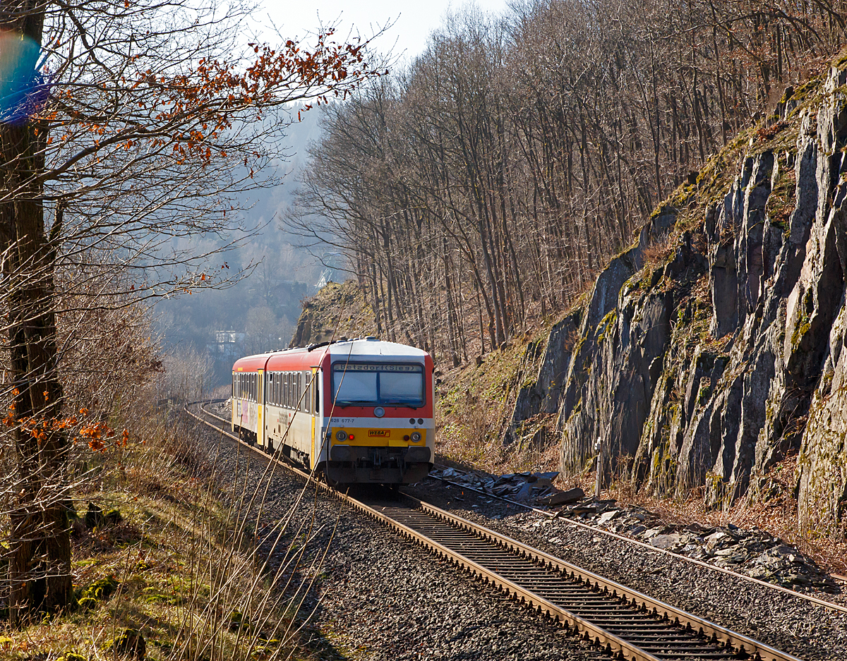 
Und hier noch vom gleichen Fotopunkt im Nachschuß....Der Dieseltriebzug 928 677-4 / 628 677-7 der Westerwaldbahn (WEBA) fährt am 15.02.2015, als RB 96  Hellertalbahn  die Verbindung Neunkirchen-Herdorf-Betzdorf/Sieg, hier bei Km 87,8 der KBS 462 (Hellertalbahn) zwischen Königsstollen und Sassenroth (beide zu Herdorf). 

Gut zu erkennen ist, hier liegt noch das alte zweite Gleis der einstigen zweigleisigen Hauptstrecke.