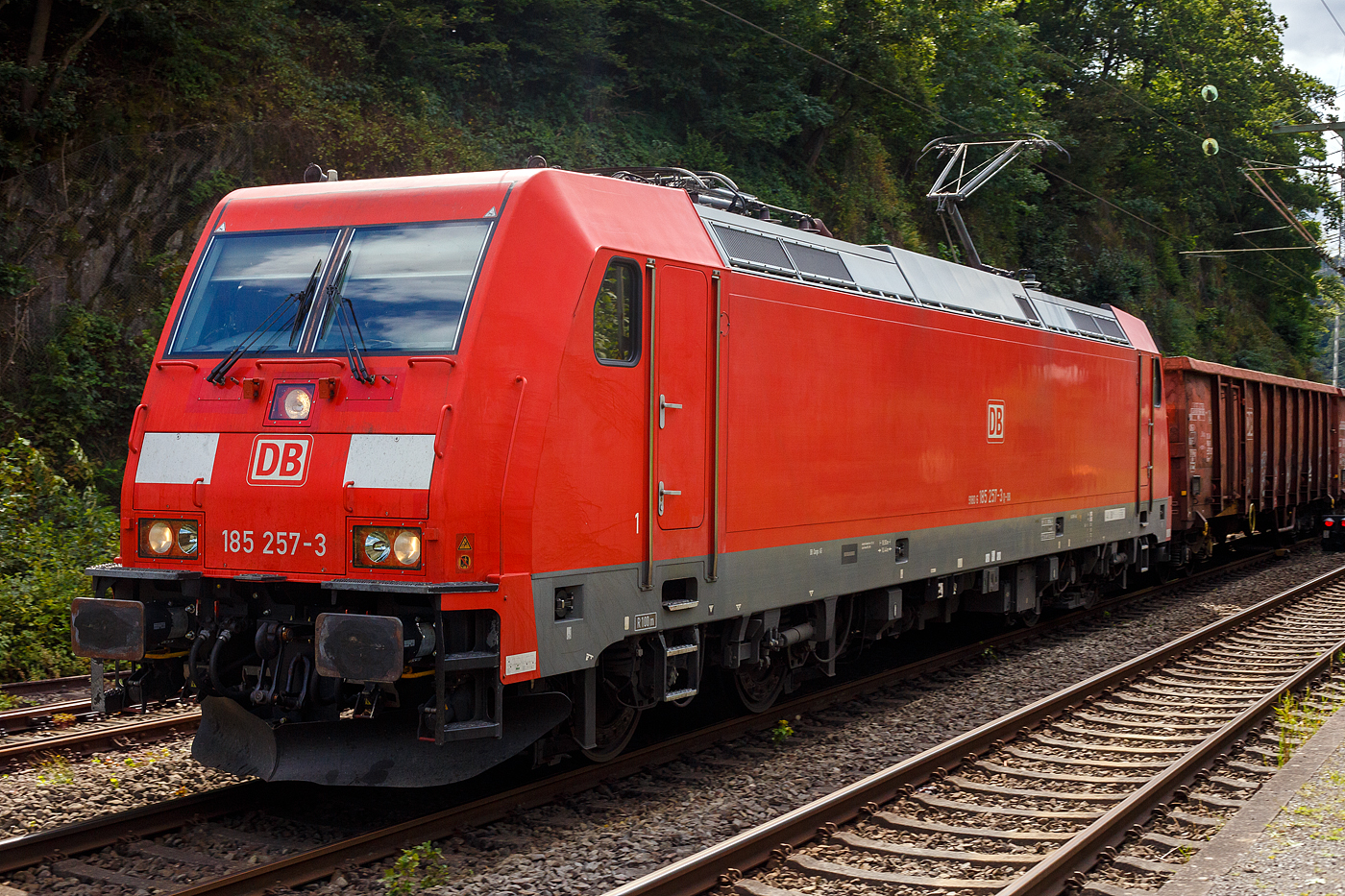 Die 185 257-3 (91 80 6185 257-3 D-DB) der DB Cargo AG fährt am 08 August 2024 mit einem gemischten Güterzug (vier Wagen der Gattung Eaons-x 059, sowie sechsachsige Coilwagen der Gattung Sahmms) durch Scheuerfeld (Sieg) in Richtung Siegen bzw. Kreuztal.

Die TRAXX F140 AC2 wurde 2006 bei Bombardier in Kassel unter der Fabriknummer 34104 gebaut. Sie hat die Zulassungen für Deutschland und Österreich.
