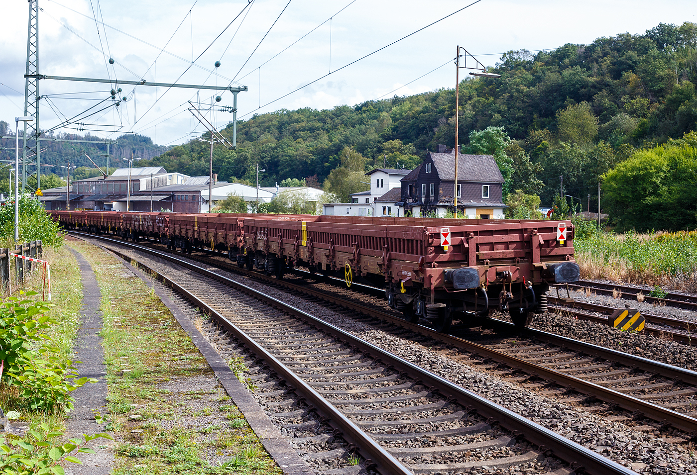 Leerer vierachsiger  Drehgestell-Flachwagen (Niederbordwagen) mit Seitenborden, Stirnw�nden (Stahl-Bordw�nden) und Stahlfu�boden, 31 80 3944 092-7 D-DB, der Gattung Res-x 679.1, der DB Cargo AG, am 11 September 2024 im Zugverband (Zugschluss) bei einer Zugdurchfahrt in Scheuerfeld (Sieg).

Der Wagen ist f�r den Transport von schweren Sch�ttg�tern vorgesehen. Der Wagen ist in Ganzstahlbauweise unter Verwendung von Profilen und abgekanteten Blechen hergestellt. Als Material f�r diese Schwei�konstruktion wird vor allem St 52-3 und St 38 verwendet. Der Fu�boden besteht aus 8 mm dickem Riffelblech und wird an der Stirnseite des Wagens durch ein U-Profil und an den L�ngsseiten durch einen Flachstahl begrenzt.

Der Wagen ist an jedem Kopfst�ck mit zwei Fallrungen ausger�stet. Um die Seitenwandklappen in ihrer senkrechten Lage festzulegen, sind an jeder Wagenl�ngsseite 8 verst�rkte Gleitrungen angeordnet. Der Wagen besitzt keine Ladeschwellen. Der Wagen kann auch mit heruntergeklappten Seitenw�nden ohne Ladema��berschreitung bef�rdert werden. Der Wagen besitzt eine vom Boden aus bedienbare Feststellbremse, die auf ein Drehgestell wirkt.

TECHNISCHE DATEN:
Umgebaut aus: Res 676 im Jahr 2010
Spurweite: 1.435 mm
L�nge �ber Puffer: 19.900 mm
Drehzapfenabstand: 14.860 mm
Achsabstand im Drehgestell: 1.800 mm
Bauart der Drehgestelle: BA 853
Ladebreite: 2.530 mm
L�nge der Ladefl�che: 18.500 mm
Ladefl�che: 46,8 m�
H�chstgeschwindigkeit: 120 km/h / 100 km/h (beladen)
Eigengewicht: 25.000 kg
Maximale Ladegewicht: 55,0 t (ab Streckenklasse C) 
Kleinster bef. Gleisbogenradius: 35 m
Bremse: KE-GP (LL)
Handbremse: auf ein Drehgestell
Intern. Verwendungsf�higkeit: RIV
