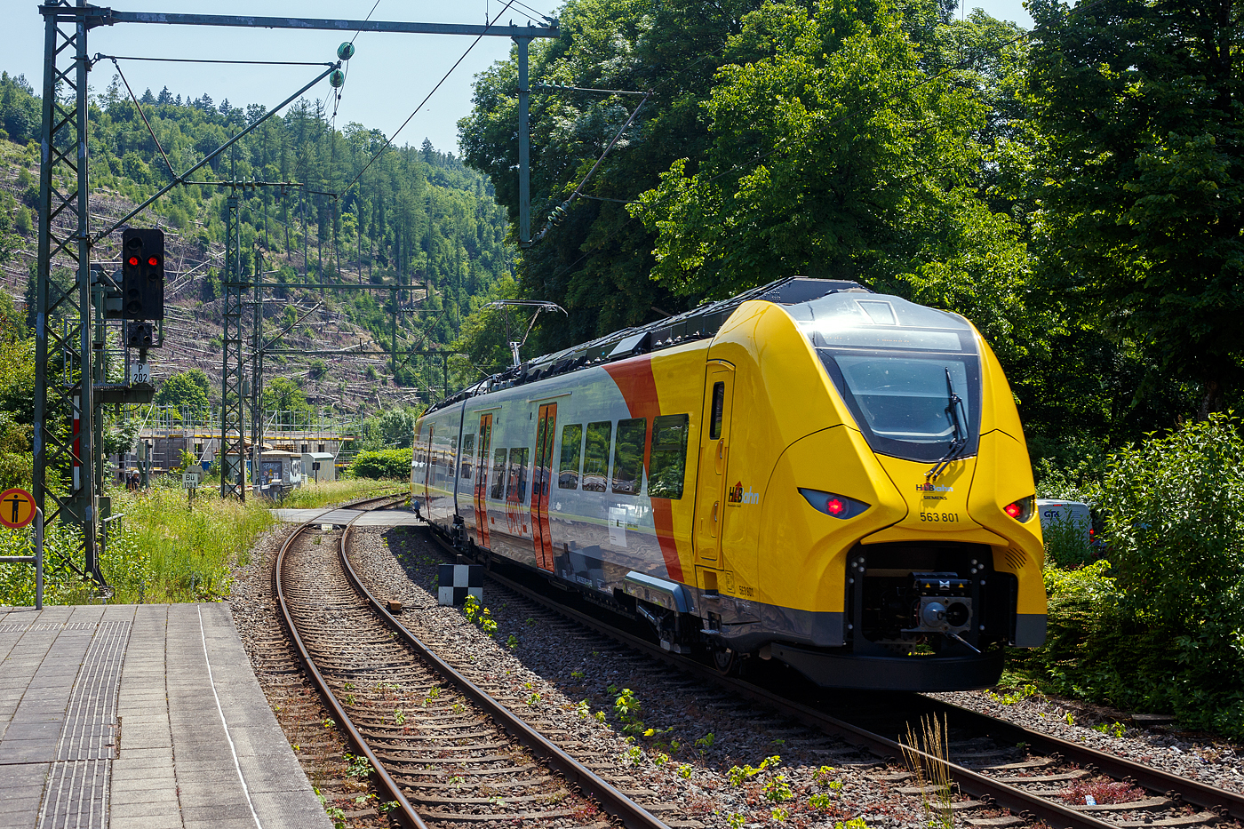 Normalerweise heißt es Dieselnetz Eifel-Westerwald-Sieg (Los 2), zudem auch die Linie RB 90  Westerwald-Sieg-Bahn  von Siegen über Betzdorf/Sieg, Au/Sieg, Altenkirchen/Westerwald und Westerburg nach Limburg/Lahn gehört. Bisher wurde die Verbindung nur mit Dieseltriebzügen der HLB vom Typ LINT 27 oder 41 gefahren. Aber die ca. 40 km lange Strecke zwischen Siegen und Au/Sieg ist elektrifiziert. Den weiteren ca. 78 km sind aber ohne Oberleitung. 

Nun wird aber auch hier elektrisch gefahren und zwar mit Hybridtriebzügen (E/Akku) vom Typ SIEMENS Mireo Plus B. Ein großer Fortschritt für den Klimaschutz am Westerwald.

Hier verlässt der HLB 563 801 / 563 901 (94 80 0563 801-0 D-HEB / 94 80 0563 901-8 D-HEB), ein zweiteiliger Hybridtriebzug (E/Akku) der BR 563 vom Typ SIEMENS Mireo Plus B der HLB (Hessische Landesbahn GmbH), am Freitag den 13 Juni 2025 den Bahnhof Kirchen/Sieg und fährt weiter in Richtung Betzdorf.