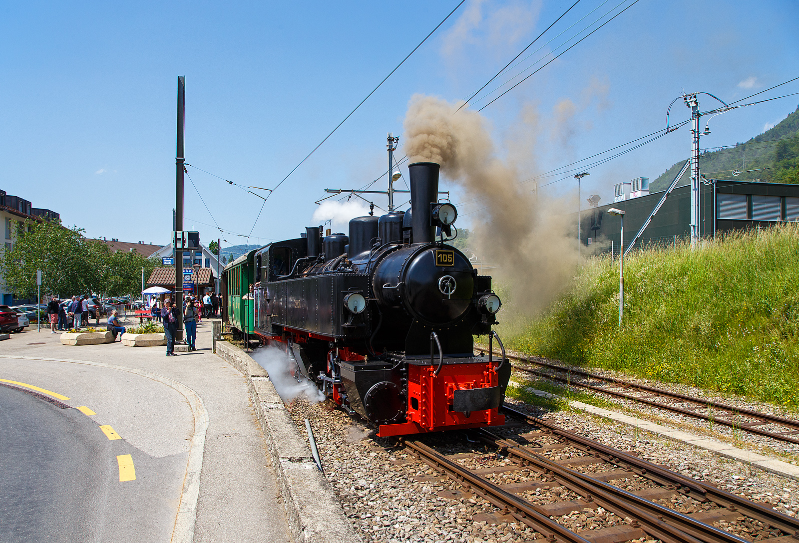 Pfingsten 2023 (Samstag 27. bis Montag 29. Mai 2023) fand bei der Museumsbahn Blonay–Chamby das Schweizer Dampffestival 2023 / Festival suisse de la Vapeur 2023 statt.

Die Mallet-Dampflok G 2x2/2 SEG 105  Todtnau“ fährt am 27.05.2023 mit dem Dampfzug der Museumsbahn Blonay-Chamby von Bahnhof Blonay nun wieder hinauf nach Chamby bzw. zum Museum Chaulin.

Für den Einsatz auf den Meterspur-Strecken in Frankreich bestellten die Deutschen Heeresfeldbahnen bei der Maschinenbau-Gesellschaft Karlsruhe sieben Mallet-Dampflokomotiven. Aus Zeitgründen wurde keine zeitgemäße neue Serie entwickelt. Man nahm alte Konstruktionsunterlagen als Grundlage. Die Auslieferung erfolgte im August 1918. Bevor die Maschinen HK 94 bis HK 100 (HK = Heeresprüfkommission für Feldbahnen) ihren Einsatzort erreichten, war der I. Weltkrieg (Waffenstillstand von Compiegné am 11. November 1918) jedoch schon beendet. Da sie nicht mehr von den Heeresfeldbahnen benötigt und nicht zum Reparationsgut zugeordnet wurden, übernahm sie das Reichsverwaltungsamt. Dieses verkaufte in den Jahren 1919/1920 die Loks.

Die Lok wurde 1918 von der Maschinenbau-Gesellschaft Karlsruhe unter der Fabriknummer 2051gebaut und von der Heeresprüfkommission für Schmalspurbahnen abgenommen als Lok „HK 95“ abgenommen, wegen dem Kriegsende kam sie auf den Heeresfeldbahnen nicht mehr zum Einsatz. So wurde sie 1919 an die Kleinbahn Voerde-Haspe–Breckerfeld als HVB 28 verkauft. Die Kleinbahn Voerde-Haspe–Breckerfeld wurde elektrifiziert, und die  Nr. 28  wurde 1925 an die Zell-Todtnau-Eisenbahn (in der Nähe von Freiburg) der Süddeutsche Eisenbahn-Gesellschaft (SEG) abgegeben, wo sie die  Nummer 105  -  Todtnau  erhielt. Sie blieb bis zur Streckenstillegung der Linie im Jahre 1968 im Schwarzwald und ging gleich drauf an die Museumsbahn Blonay – Champy.
Es ist noch eine Schwesterlok erhalten geblieben, es ist die 99 5906 der HSB.

Konstruktion:
Das hintere Triebwerk mit den Hochdruckzylindern ist fest im Blechrahmen gelagert. Das vordere Triebwerk mit den Niederdruckzylindern ist mit einem Königszapfen mit dem hinteren Triebwerk verbunden, der genietete Kessel liegt mit Gleitplatten auf ihm auf. Seitliche Blattfedern halten das Triebwerk in einer mittigen Stellung. Beide Triebwerke haben einen Innenrahmen.

Der Dampf wird erst zu den hinteren Zylindern geleitet, von dort gelangt er über flexible Leitungen in die vorderen Zylinder. Alle Zylinder verfügen über Flachschieber und außenliegende Heusinger-Steuerung mit Hängeeisen.

Die Loks verfügen über eine Wurfhebel-Handbremse und eine Dampfbremse als Zusatzbremse. Je nach Bahn wurden später Saugluft- oder Druckluftbremse als Zugbremse nachgerüstet.

Auf dem Kessel sitzen zwei Sanddome, einer für jedes Triebwerk.

TECHNISCHE DATEN:
Hersteller Maschinenbau-Gesellschaft Karlsruhe (MBK)
Baujahr: 1918
Betriebsgattung: K 44.9
Kurzbezeichnung: B' B n4vt
Spurweite: 1.000 mm
Kurzbezeichnung: B' B n4vt
Länge über Puffer: 9.400 mm
Höhe über SO: 3.800 mm
Achsstand im Triebwerk: 1.400 mm
Treibraddurchmesser: 1.000 mm
Leergewicht: 28,5 t
Dienstgewicht: 34,4 t
Höchstgeschwindigkeit: 30 km/h
indizierte Leistung: 200 kW (270 PS)
Anfahrzugkraft: 47,76 kN
kleinster befahrbarer Gleisbogen: 50 m
Kesselüberdruck: 12 bar
Kohlevorrat : 1,1 t
Wasservorrat: 3,6 m³
Zylinderanzahl: 4
Zylinderdurchmesser: 280 mm (HD) / 425 mm (ND)
Kolbenhub: 500 mm
Bremse: Knorrbremse m. Z., Wurfhebel-Handbremse

Geschichte der Mallet-Lokomotiven:
Der zunehmende Verkehr auf schmalspurigen Eisenbahnen erschloss Mallet ein anderes Wirkungsfeld. Diese Bahnen benötigten stärkere und damit größere Maschinen, als es die engen Kurven der Schmalspurstrecken zuließen. Die einzige Lösung schienen hier Lokomotiven mit schwenkbaren Fahrwerken zu sein. Dazu waren bereits die Bauarten von Fairlie und Meyer verbreitet, die schwenkbare Maschineneinheiten verwendeten. Die einzelnen Einheiten wurden mit Dampf über flexible Verbindungen gespeist, die sich jedoch stets als Schwachpunkt der Maschinen erwiesen. Mallet entwickelte stattdessen eine Bauart mit zwei Fahrwerken, von denen nur das vordere, unter der Rauchkammer befindliche Fahrwerk schwenkbar gelagert war, während der Kessel fest auf dem anderen Fahrwerk ruhte. Damit reduzierte sich die Zahl der flexiblen Verbindungen um die Hälfte. Der wesentliche Unterschied der Konstruktion von Mallet im Vergleich zu den Bauarten Fairlie und Meyer war aber die perfekte Anwendung eines Verbundtriebwerkes. Der Frischdampf wird zunächst zu den Hochdruckzylindern des fest gelagerten Fahrwerks geleitet und nach dem Auslass in die Niederdruckzylinder des vorderen beweglichen Fahrwerks. Die dorthin führende bewegliche Dampfleitungsverbindung war wegen des geringeren Drucks besser beherrschbar als bei reiner Frischdampf-Versorgung. Diese Bauart ließ Mallet sich 1884 patentieren.

Dampflokomotiven haben im Allgemeinen zwei Arbeitszylinder, die Mallet-Loks besitzen diese Einrichtungen doppelt, also 4 Zylinder mit zugehörigen Triebwerksgruppen. Der Abdampf der ersten ist gleichzeitig der Arbeitsdampf der zweiten Zylindergruppe.
