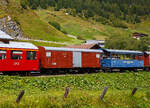 Abgestellt in Realp (Uri) von/bei der DFB Dampfbahn Furka-Bergstrecke AG am 07 September 2021, aufgenommen aus einem fahrenden MGB-Zug heraus:

Links:
Der ehemalige G�terwagen VZ K 63 der Visp Zermatt Bahn, ein schmalspurige vierachsige gedeckter G�terwagen. Der Wagen wurde 1906 von SIG (Schweizerische Industrie-Gesellschaft) in Neuhausen am Rheinfall gebaut und an die damalige VZ- Visp Zermatt Bahn geliefert. 1959 wurde er erst als BVZ K 2423 (Brig-Visp-Zermatt-Bahn), dann doch als BVZ K 2423 gef�hrt und 1973 BVZ Gak-v 2443 bezeichnet. Noch vor dem Zusammenschluss am 01. Januar 2003 der BVZ mit der Furka-Oberalp-Bahn (FO) in die heutige Matterhorn-Gotthard-Bahn ging er 2002 als X 4943 zur DFB. Aktuell ist er als DFB X 4921 gef�hrt, er dient der Abteilung Zugf�rderung und Werkst�tten (ZfW) als Magazinwagen, ist aber als BVZ Gak 2443 beschriftet.  Wagen hatte urspr�nglich 2 Plattformen, der Kasten war ganz aus Holz, 1965 wurde er von SIG umgebaut.

TECHNISCHE DATEN:
Hersteller: SIG
Baujahr: 1906
Spurweite: 1.000 mm (Meterspur)
L�nge �ber Puffer : 11.100 mm
L�nge des Wagenkastens: 9.600 mm
Breite: 2.400 mm
Drehzapfenabstand: 6.500 mm
Achsabstand im Drehgestell: 1.400 mm
Eigengewicht:  10,8 t (angeschrieben 11.320 kg)
Ladegewicht:  10 t
Ladefl�che: 22,4 m� (angeschrieben 19,9 m�)
Ladevolumen: 43,0 m�
Zul. H�chstgeschwindigkeit: 55 km/h
Bremsen: 	automatische Vakuum- und Handbremse

Rechts:
Der blaue zweiachsige Aussichtswagen C 2354 mit drei Rollstuhlpl�tzen.  Der Wagen wurde 1892 von SIG (Schweizerische Industrie-Gesellschaft) in Neuhausen am Rheinfall, als dreiachsiger 2.Klasse Personenwagen JS B�  1173. f�r die damalige Jura-Simplon-Bahn (JS) gebaut und geliefert. Mit der Verstaatlichung der JS zu den Schweizerischen Bundesbahnen (SBB) am 1. Mai 1903 wurde er dann zum SBB Br�nig B� 223, ab 1920 als C� 653 und ab 1994 SBB Br�nig X� 9954 gef�hrt. Im Jahr 1971 wurde er ausgemustert und gin an die VFDK ab 1985 BDB (Ballenberg Dampfbahn) im Jahre 1992 ging er dann an die DFB. Zwischen 1992 und 1995 erfolgte ein Neuaufbau, die Mittelachse wurde entfernt (Achsabstand 6.000 mm), dabei wurde aber jegliche historische Substanz zerst�rt. Die Inbetriebnahme bei der DFB erfolgte 1995 als Aussichtswagen C 2354.  Der Aussichtswagen  wurde 2005 von der Wagenwerkstatt Aarau f�r drei Rollstuhlpl�tze und den Rollstuhl-Verlad umgebaut. Der Wagen besitzt Seitenrolls, verglaste Stirnfenster und seitliche �ffnungen (herausnehmbare Seitenwandst�cke) f�r den Rollstuhl-Verlad mittels Hebelift. 

Bereits ab 2020 wurde der Wagen von der DFB zum Verkauf angeboten, ansonsten sollte er verschrottet werden. So ist dies wohl eines der letzten Bilder von ihm, denn er wird aktuell nicht mehr gelistet.

TECHNISCHE DATEN:
Hersteller: SIG
Baujahr: 1892
Spurweite: 1.000 mm (Meterspur)
L�nge �ber Puffer: 10.100 mm
Achsstand: 6.000 mm
Eigengewicht 7,1 t
Sitzpl�tze: 36 und 3 Rollstuhlpl�tze.
Stehpl�tze: 16
Beleuchtung: elektrisch ab Batterie
Heizung: Durchgang
Bremsen: Vakuum- und Handbremse
Bemerkung: letzte Revision R1 Mai 2017	
